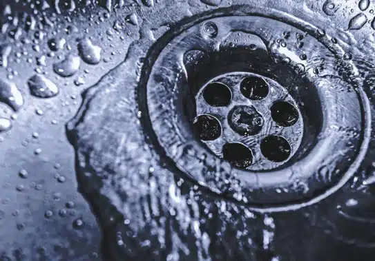 water going down drain in kitchen sink.