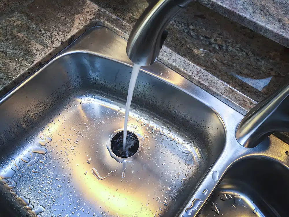 water pouring out of faucet into kitchen sink in frisco, TX.